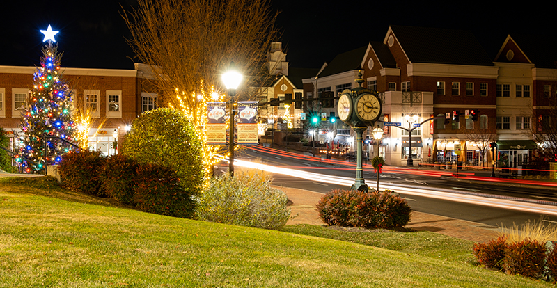2023 Christmas tree at night in Old Town Square, with the Clock